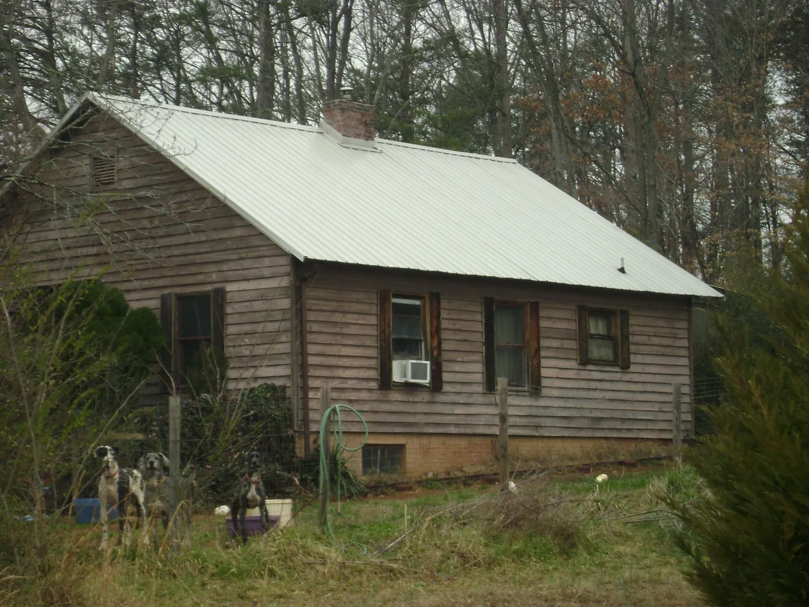 White metal roof on an old wood sided farmhouse, from a Metal Roof Installation job in Richmond